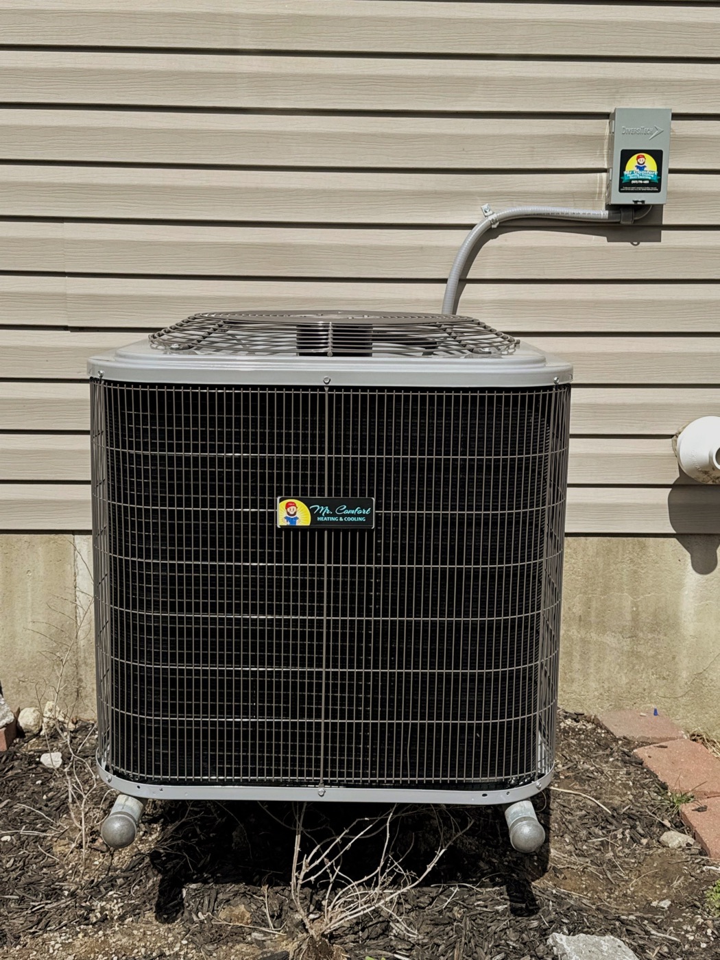 Air conditioning unit with Mr. Comfort branding installed beside a home
