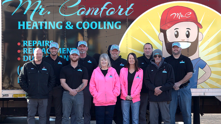 Mr. Comfort team standing together in front of the company truck